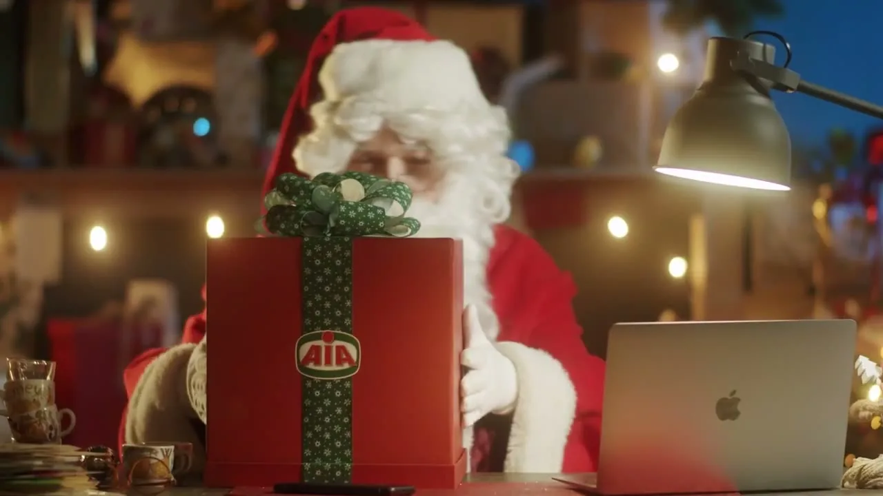 Santa with an AIA gift and a laptop, from a Fornace Christmas film